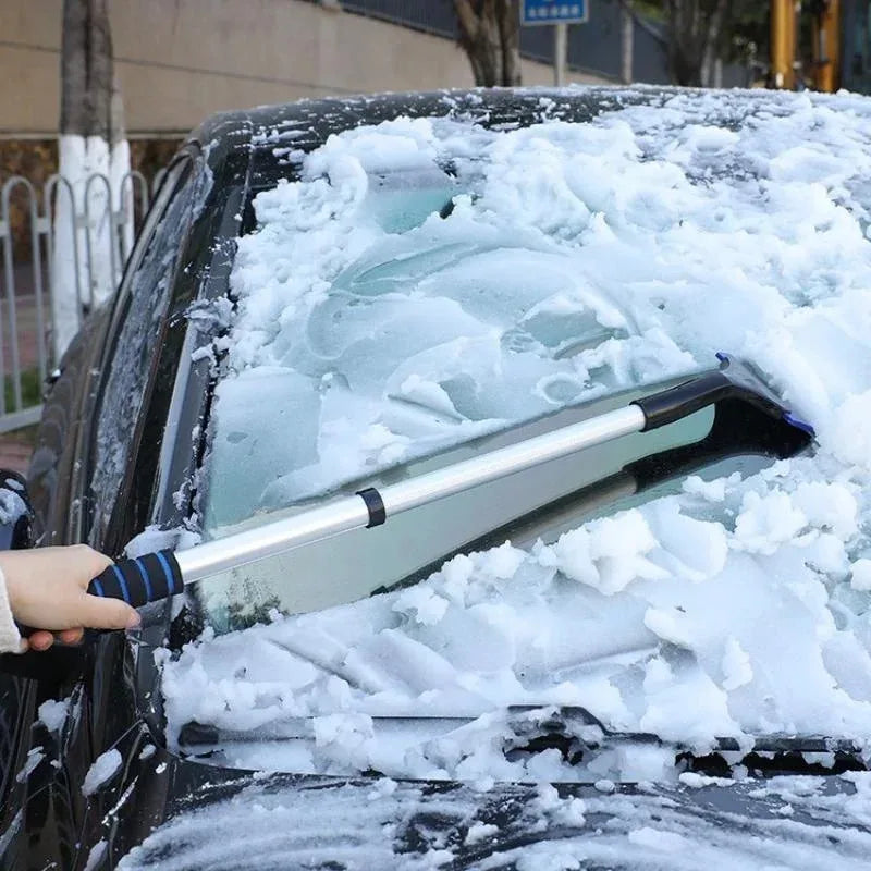 Extendable scraper in use on a car windscreen